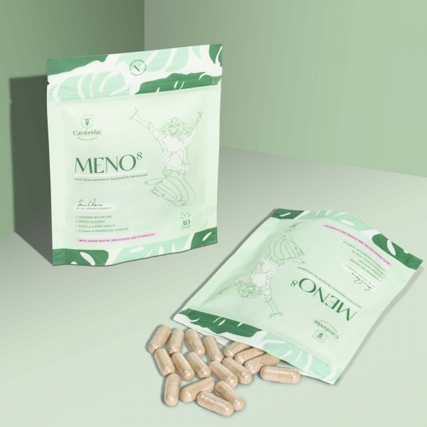 Two packets of Meno8 supplements. One packet is upright and the other is laying down with pills spilling out of the open packet.